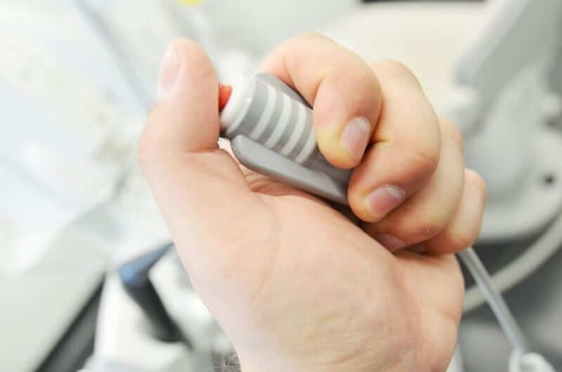 Person holding the Dental Button