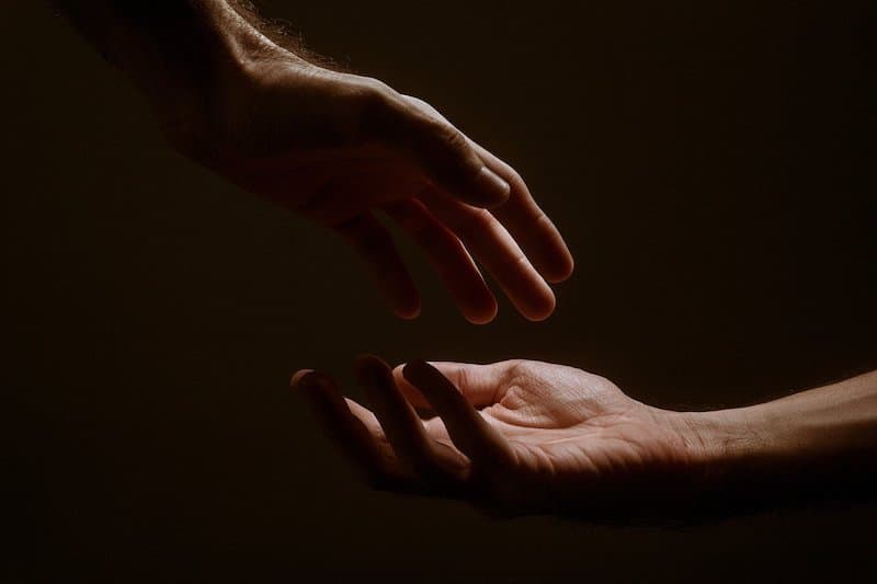 Two hands about to touch, signifying empathy