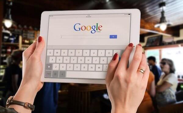 Woman doing a Google search on a tablet